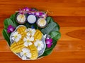 Mango sticky rice a thail sweet dessert with purple orchids and white plumeria flowers