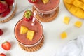 Mango strawberry smoothie with chia seeds on white kitchen table Royalty Free Stock Photo