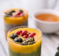 Mango turmeric chia pudding with berry fruit