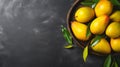 Mangoes In Wooden Bowl On Dark Gray Background