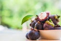 Mangosteen and cross section showing the thick purple skin and white flesh of the queen of friuts, Delicious mangosteen fruit