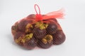 Mangosteen Fruit in Mesh bag 1 kilo white background.