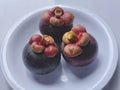 Mangosteen fruit on a white plate