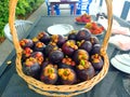 Mangosteen fruits in rattan basket on table