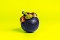 Mangosteen isolated on yellow background. Mangosteens, the famous delicious fruit from Thailand, In Asia it also known as The Quee