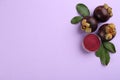 Mangosteen powder and fruits on violet background, flat lay. Space for text