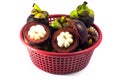 Mangosteen in red basket isolated Royalty Free Stock Photo