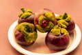 Mangosteen whole fruits lie on a white plate close up dessert asia