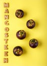 Mangosteens on yellow background. Tropical fruits, healthy food background. Summer concept. Top view, copy space, flat lay