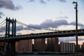 Manhattan bridge, buildings and light pole before sunset