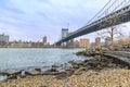 Manhattan bridge and Midtown Manhattan from Peddle beach in Brooklyn, New York Royalty Free Stock Photo