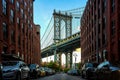 Manhattan bridge seen from a narrow alley enclosed by two brick buildings Royalty Free Stock Photo