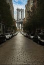 Manhattan bridge seen from Washington St alley enclosed by two brick buildings. Royalty Free Stock Photo