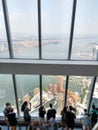 Manhattan, New York. August 2, 2019: People looking through the window of One World Observatory. Photo taken in a sunny summer day