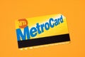 New York City Metrocard on orange background. Ticket for public transit in NYC