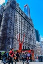 Manhattan, New York, USA - April 10, 2019: streets, food cart, building and people of Manhattan, Broadway corner Cedar Street,