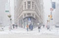 The big snow storm in the street of Manhattan. Cold windy snowy winter day. A few people walking in the street.