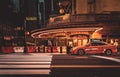 Manhattan East 42nd Street night life typical yellow cab. Grand Central Station and pedestrian zebra crossing .