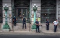 NYPD police officers gathered around keeping watch over the protest. The City Hall building with graffiti scrawled across its wall Royalty Free Stock Photo