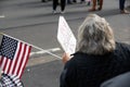 Lady holding sign. De Blasio disgrace NYC. Protest sign against Mayor of NYC