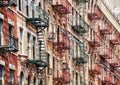 Manhattan old residential buildings with fire escapes, New York