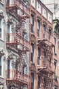 Manhattan old residential buildings with fire escapes, New York