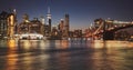 Manhattan skyline and Brooklyn Bridge reflected in water at dusk, New York City, USA Royalty Free Stock Photo