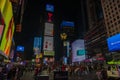 Manhattan skyscrapers come to life at night, with vibrant LED billboards lighting up Broadway and crowds of people bustling arou