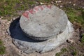 Manhole with the concrete cover on the concrete basement Royalty Free Stock Photo