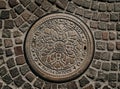 Manhole cover in pavement in Budapest, Hungary 11. August 2023