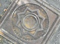 Manhole cover with the Crespi family logo Royalty Free Stock Photo