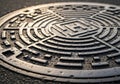 Manhole cover with geometric patterns featuring concentric circles and Royalty Free Stock Photo