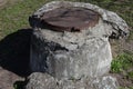 Manhole with the cover on the high concrete basement Royalty Free Stock Photo