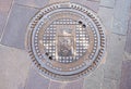 Manhole cover on the pavement at Trento city. Italy Royalty Free Stock Photo