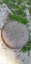 Manhole cover. Photo. Metal cover on the city sidewalk. Street exterior