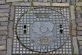 Manhole cover with portraits of the royal pair of the Netherlands