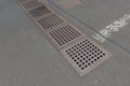 Manhole drainage grates frame rusty metal steel cover grid grill in asphalt Royalty Free Stock Photo