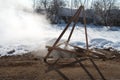 Manhole with hot white steam in winter time on street, broken sewage system. Royalty Free Stock Photo