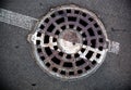 Manhole with metal cover in asphalt with white road marking line Royalty Free Stock Photo