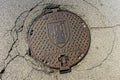 Manhole, sewer cover on the old street