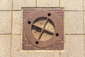 A manhole on a tiled sidewalk Royalty Free Stock Photo