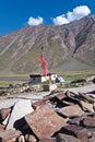 A mani wall and a prayer flag near Rangdum, Zanskar, Ladakh, India Royalty Free Stock Photo