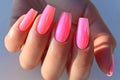 Manicure closeup. Woman pink nails close-up. Nail care in beauty salon. Spa healthy treatments for female hands. Fashion bright