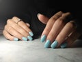 Manicure with a glossy blue solid coating.