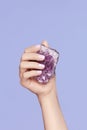 Manicure. Hand With Stylish Nails Holding Purple Gemstone