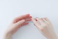 Manicure. The hands of caucasian woman trims the cuticle with nail scissors Royalty Free Stock Photo