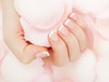 Manicure, Hands spa Beautiful woman hands, soft skin, beautiful nails with pink rose flowers petals. Healthy Royalty Free Stock Photo
