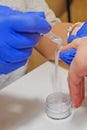 Manicure master applying acrylic powder on the woman long nails in a beauty salon Royalty Free Stock Photo