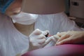 Manicure. Master manicurist varnishes the gel on the female nails. Local lighting.