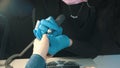 Manicure master in mask doing manicure - preparing nail for the covering and cleans the cuticle using device Royalty Free Stock Photo